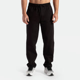 a fit man  wearing pants black with shoes 