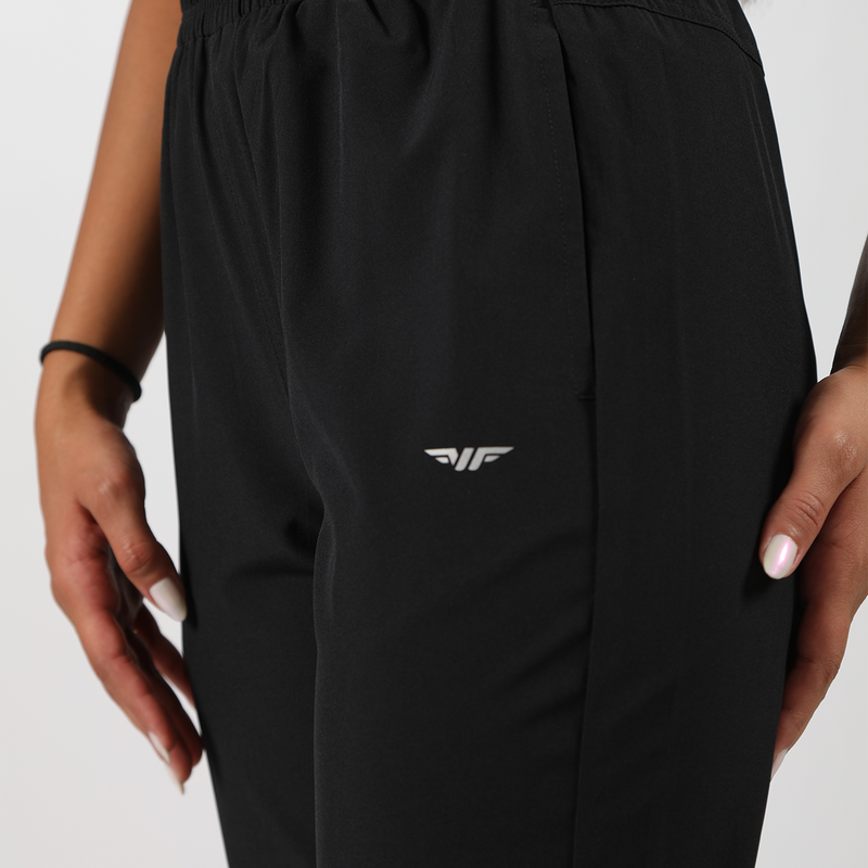 close up view of logo on pocket pants ,plus the background is light grey