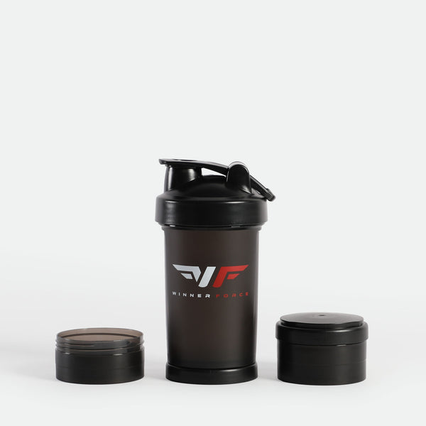 Black shaker bottle with "Winner Force" logo in red and silver; two detachable compartments beside it on a white background. Sleek, modern design.