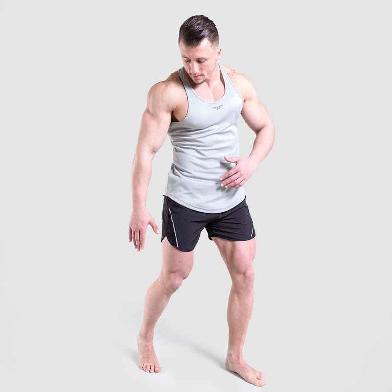 a fit man wearing tank grey  with shot black 