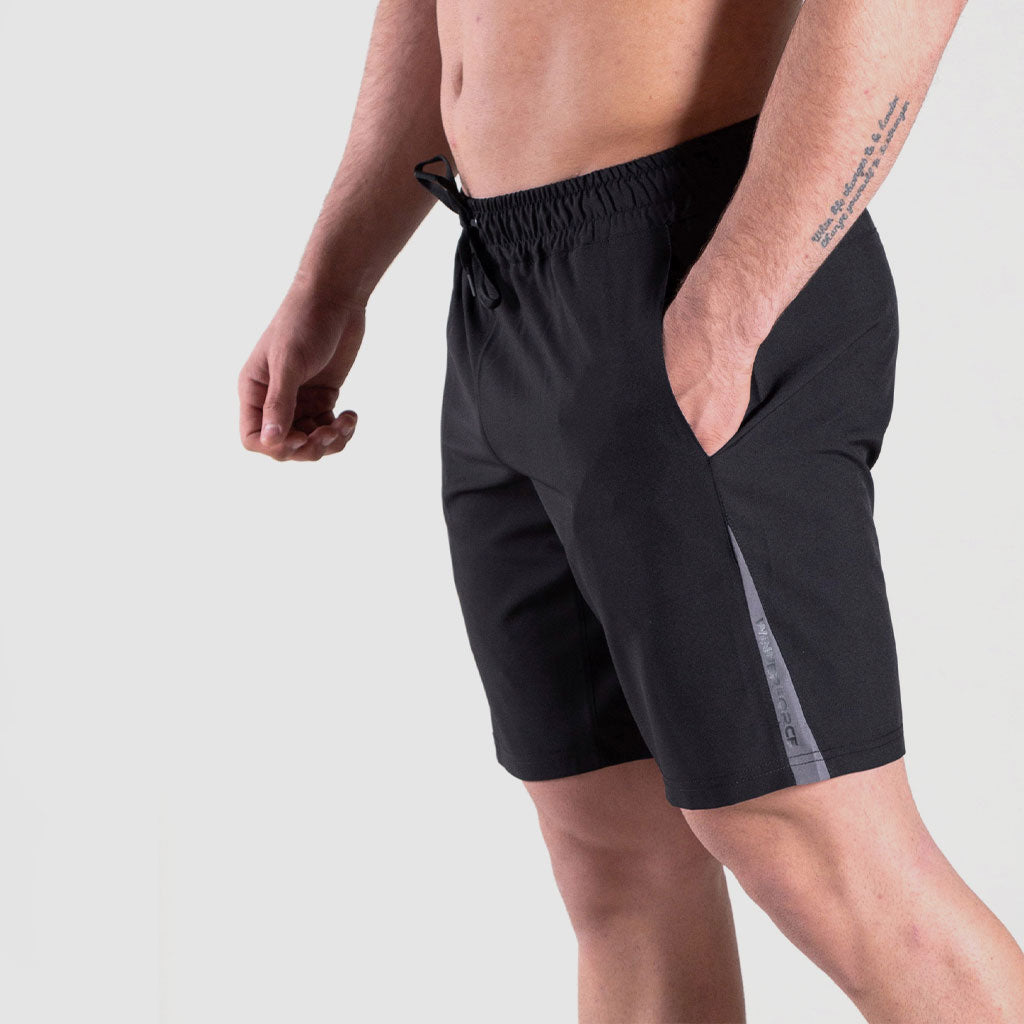 close up view for fit man stand at right and wearing short black 