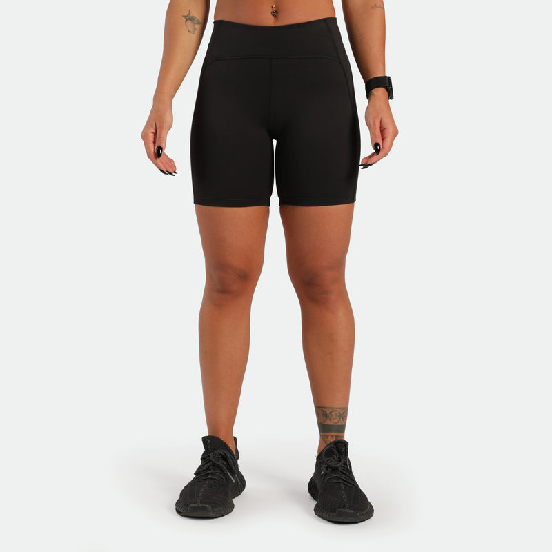 a fit woman wearing short black with shoes black 