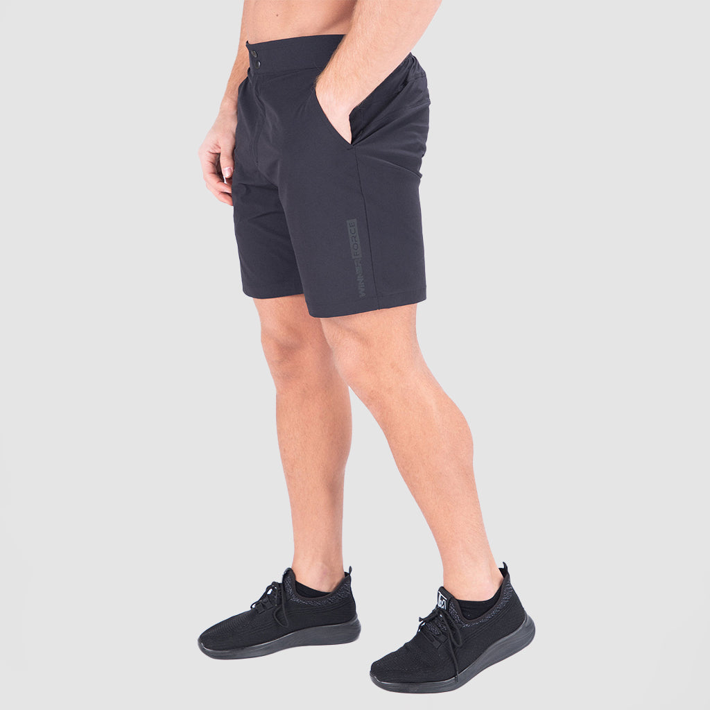 a fit man  stand at right and wearing  short black with shoes 