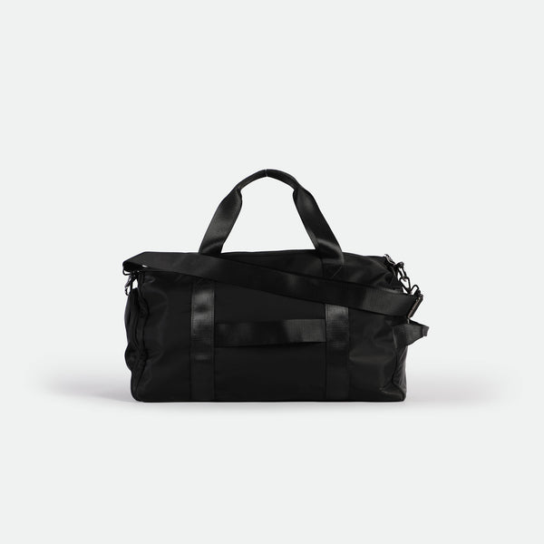 a back view for A black duffel bag with short handles and a shoulder strap.