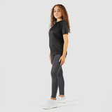a fit woman wearing t-shirt black with legging and sneakers 