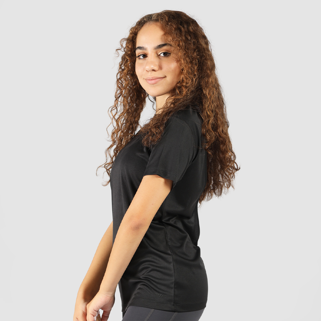 a fit woman stand at right and wearing  t-shirt  black with legging black 