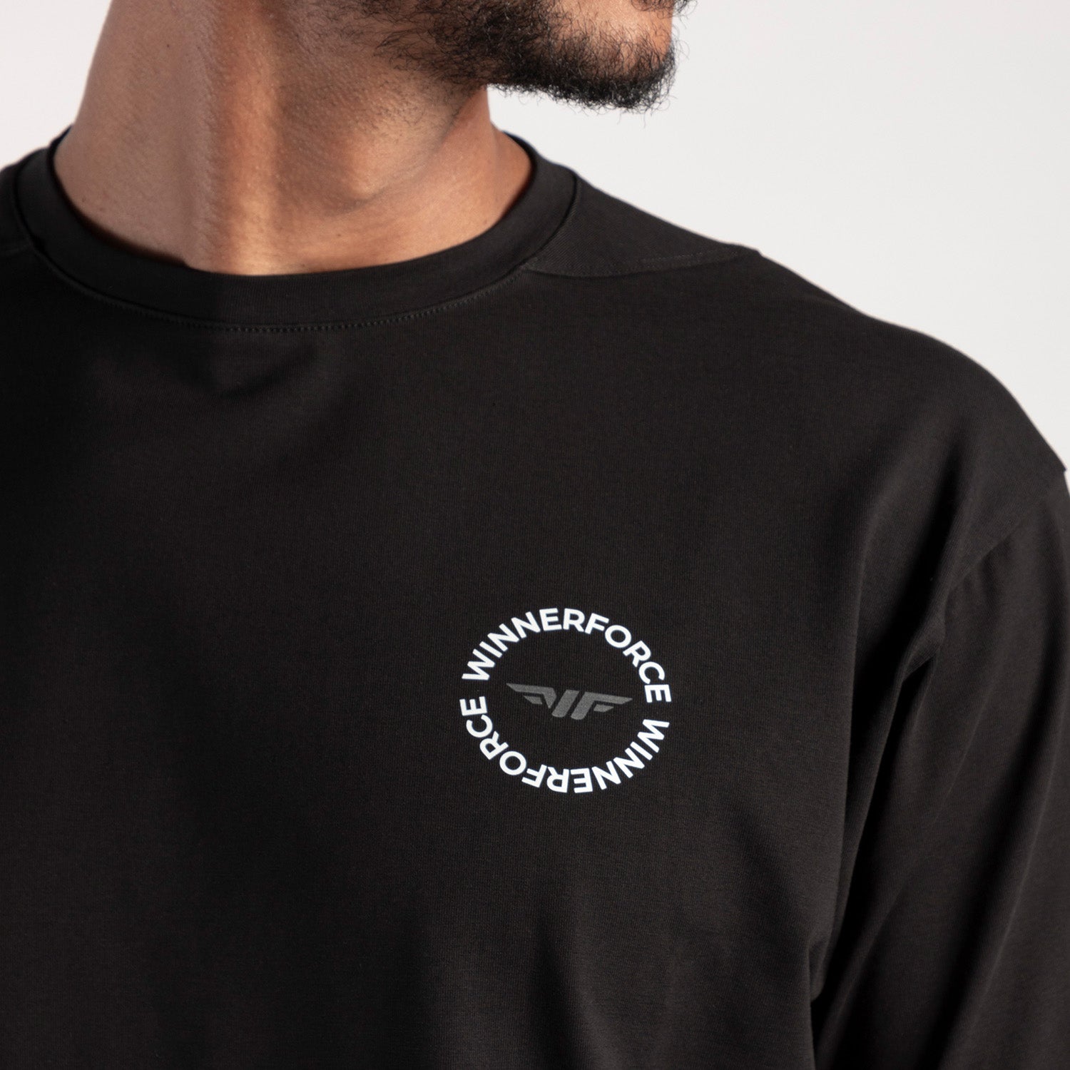 close up view for fit man wearing t-shirt black  with logo 