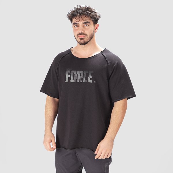 A man wearing a black oversized t-shirt with the text 'FORCE' printed in large letters on the chest.