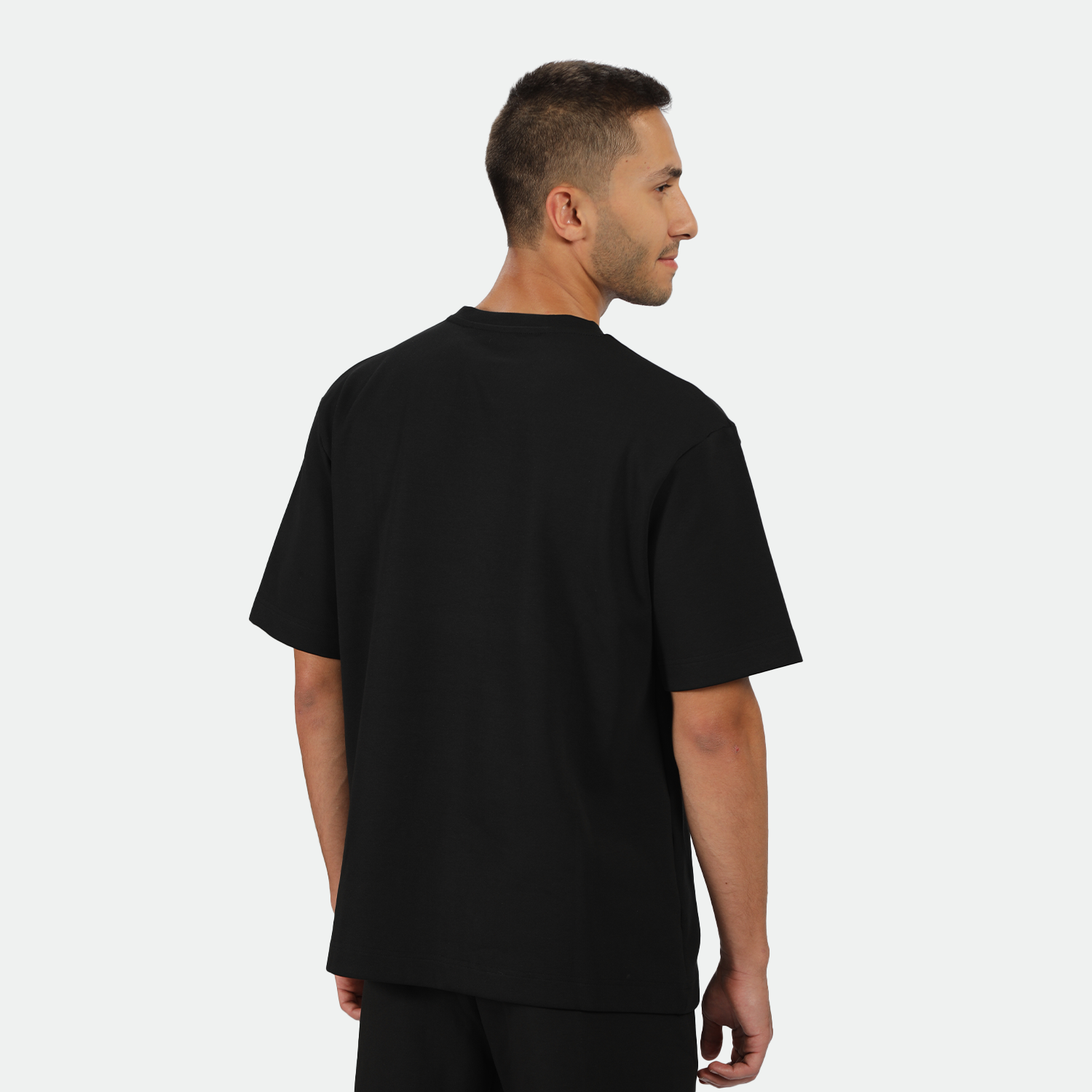 a back view for fit man wearing t-shirt black with pants black 