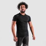 a fit man waring t-shirt black with pants grey 