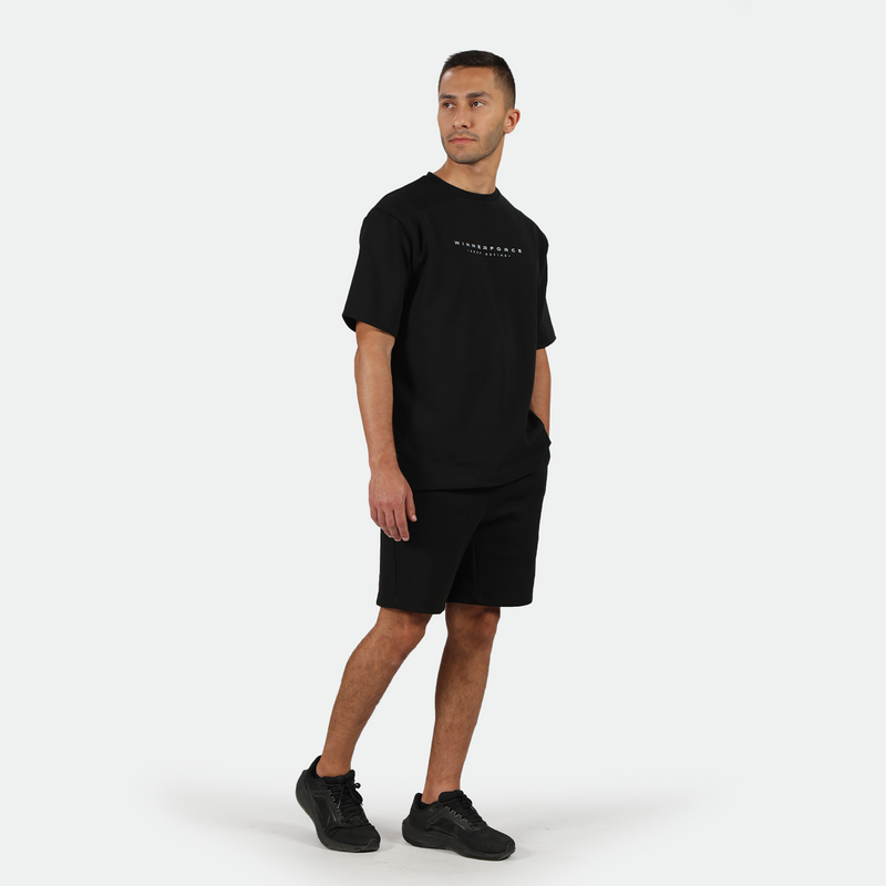 a fit man wearing matching color set black with shoes black 