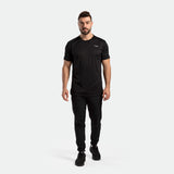 a fit man wearing matching color black  t-shirt with logo and pants and shoes 