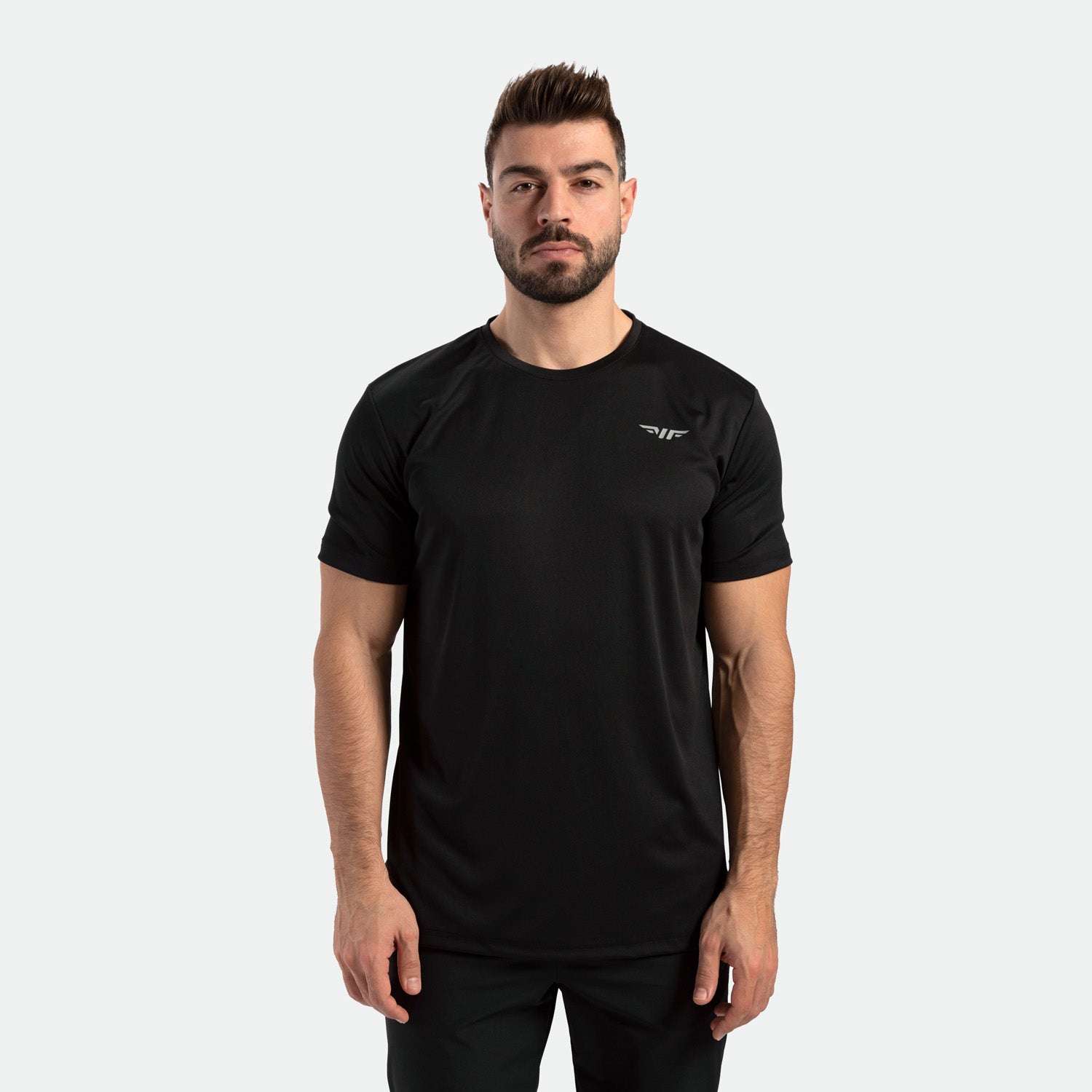 a fit man wearing matching color set ,t-shirt with logo and pants 