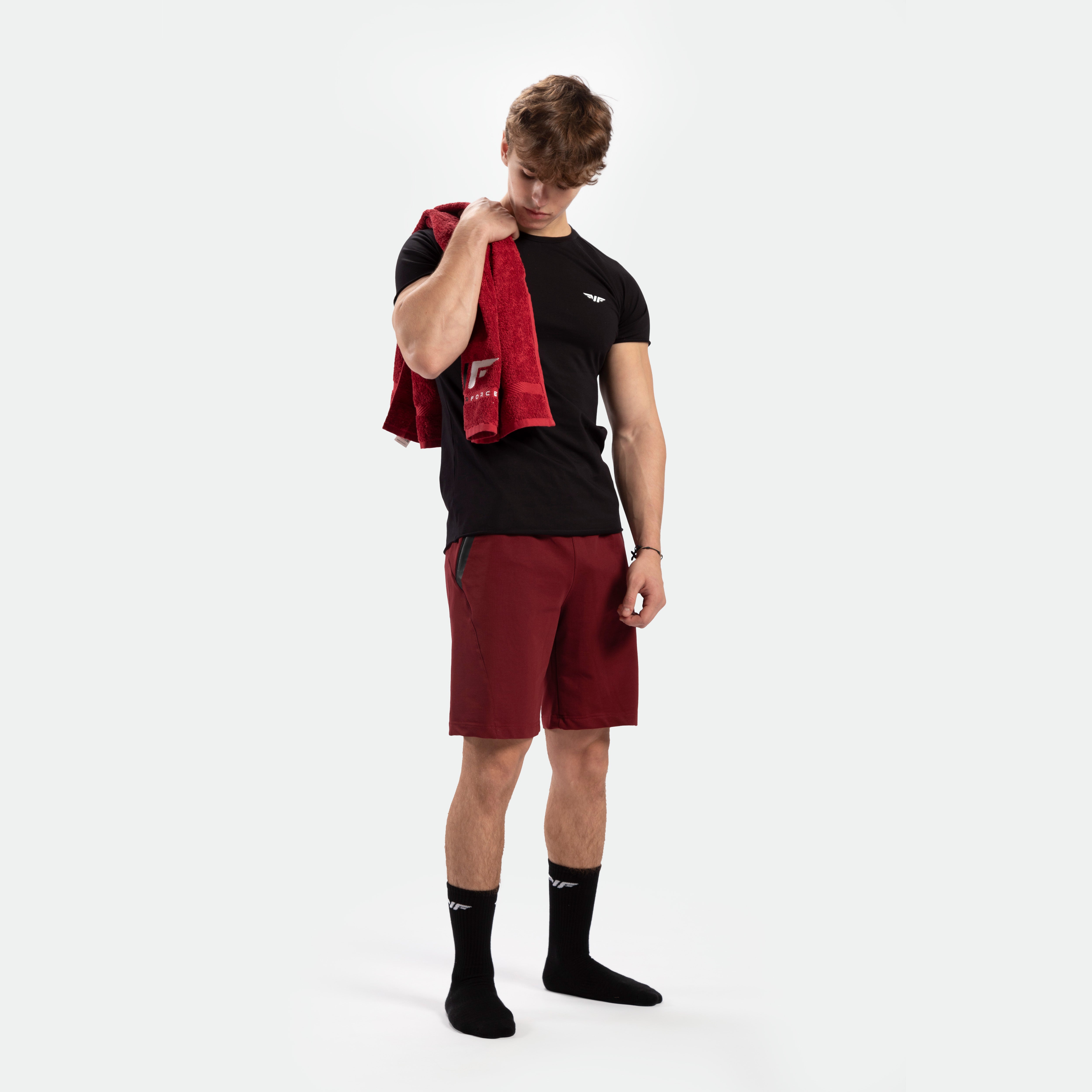 a fit man wearing t-shirt black with short red ,plus socks black 