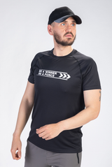 Person wearing a black t-shirt with motivational text on a white background