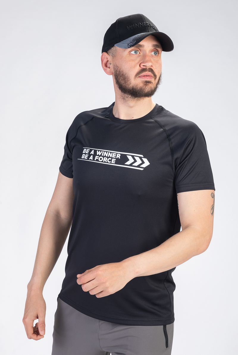 Person wearing a black t-shirt with motivational text on a white background