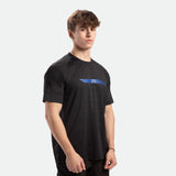 a fit man stand at right and wearing camo t-shirt black with pants black 