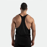 a back view for fit man wearing tank black with pants black 