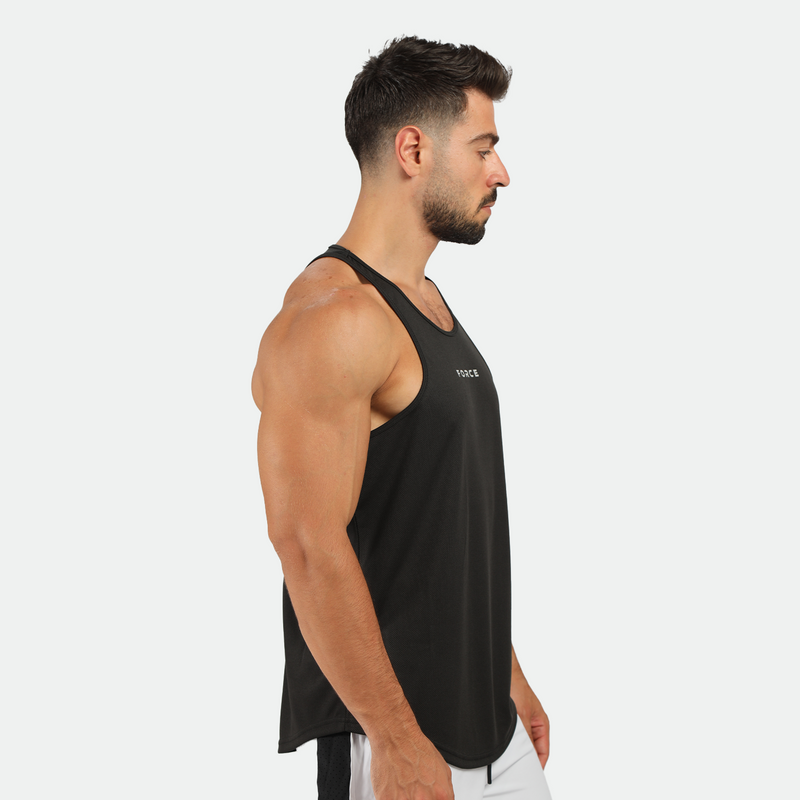 a fit man stand at right and wearing tank black  with pants marl light grey 