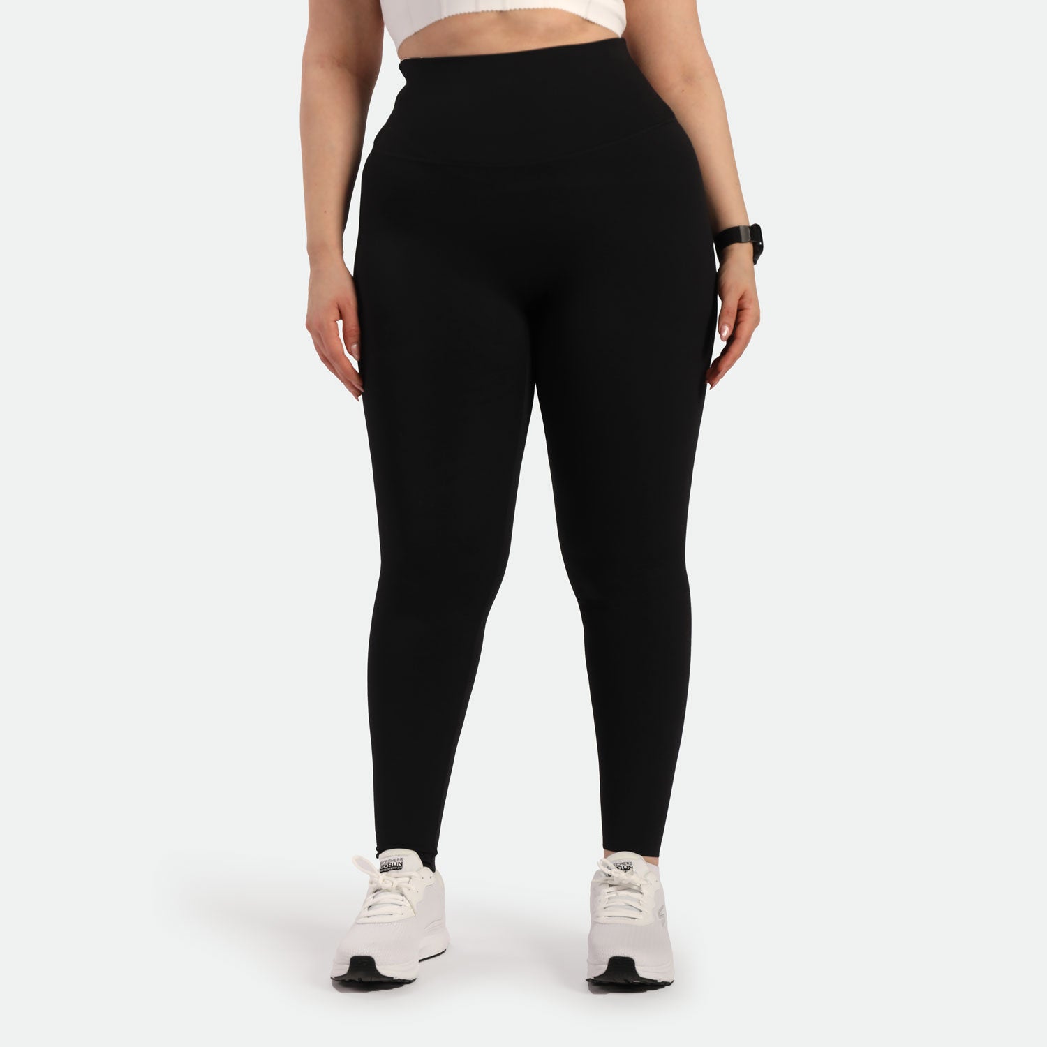 a fit woman wearing legging black with shoes white 