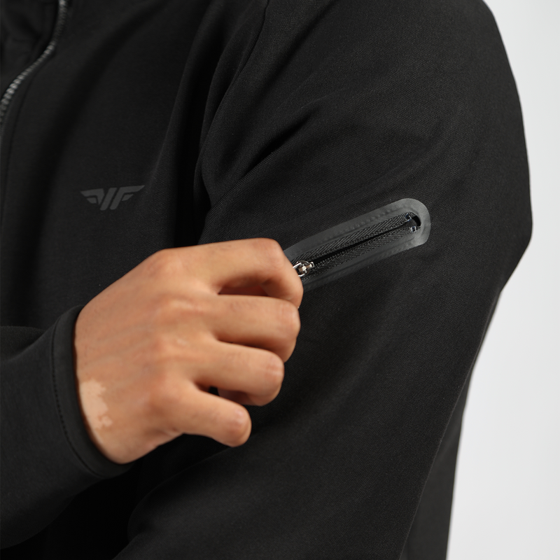 close up view  for person wearing tech zipped hoodie  black for pocket with zipper and here hand on it 