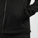 close up view for man wearing  tech zipped hoodie black with pocket ,here hand inside 