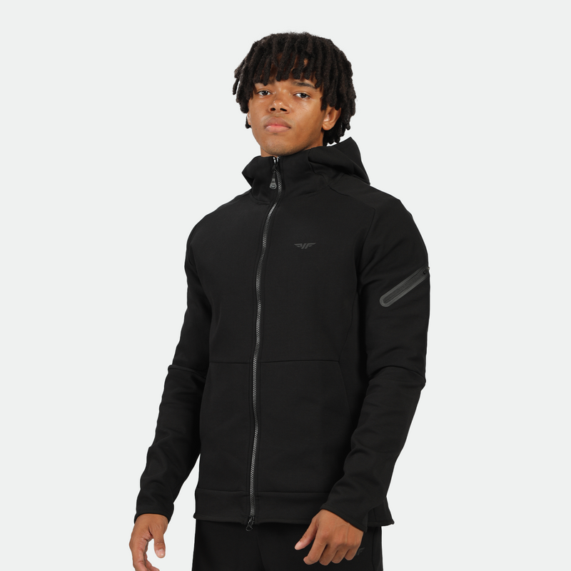 a fit man stand with confidence and wearing tech zipped hoodie black with pants black  