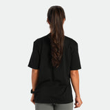 a back view for fit woman wearing t-shirt black with short   sage grey 