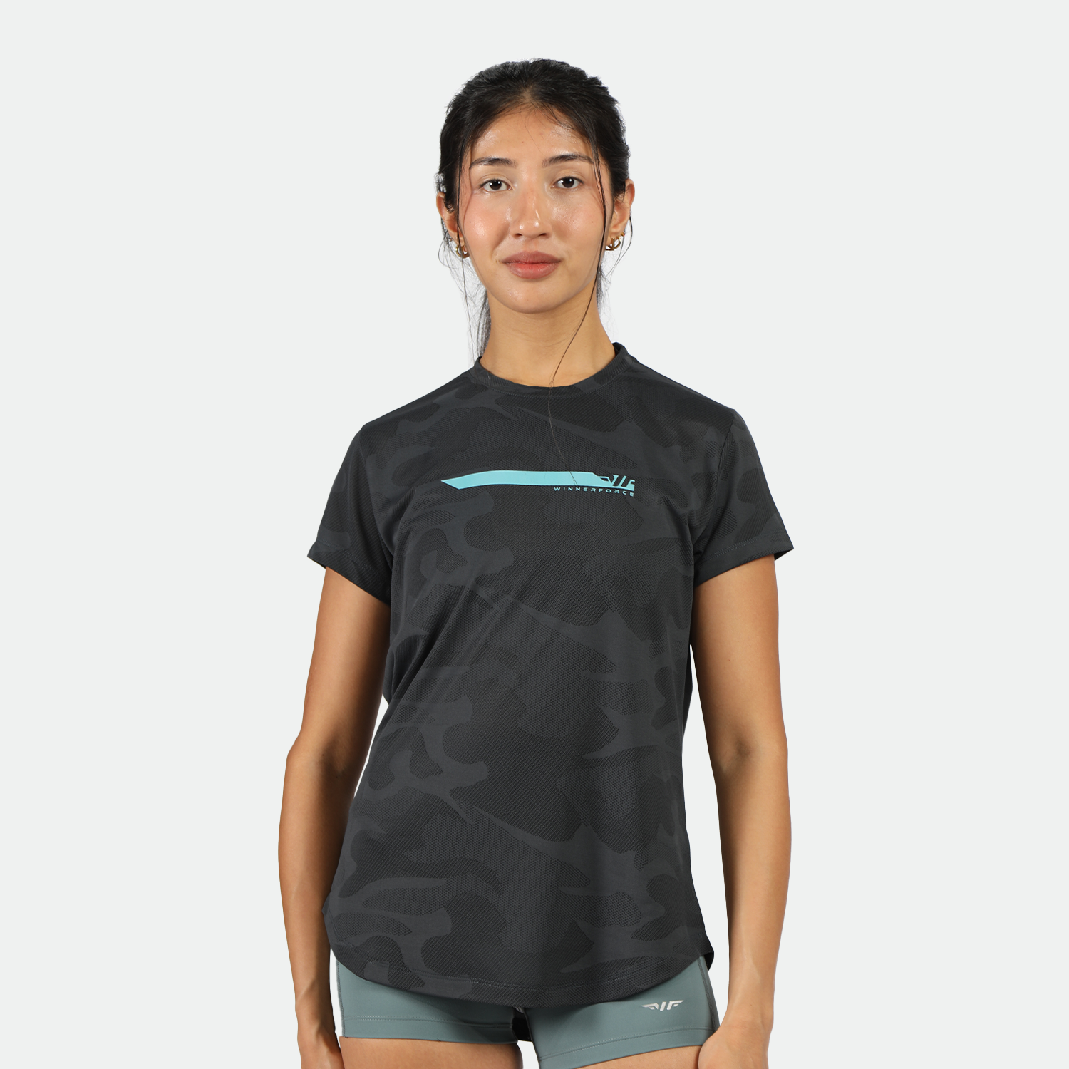 a fit woman wearing camo black t-shirt with logo and shorts green 