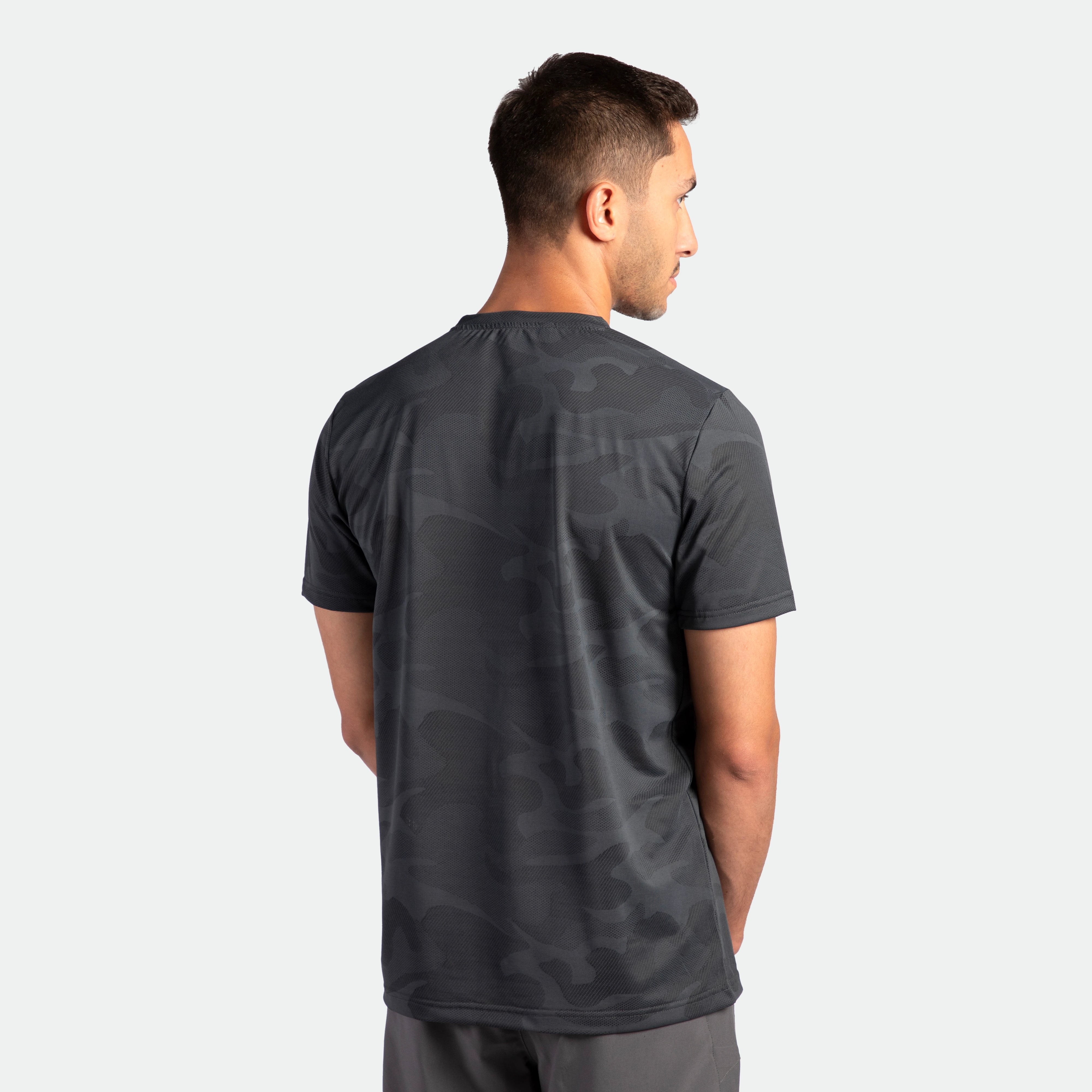 a back view for fit man wearing t-shirt camo graphite blue with pants grey 