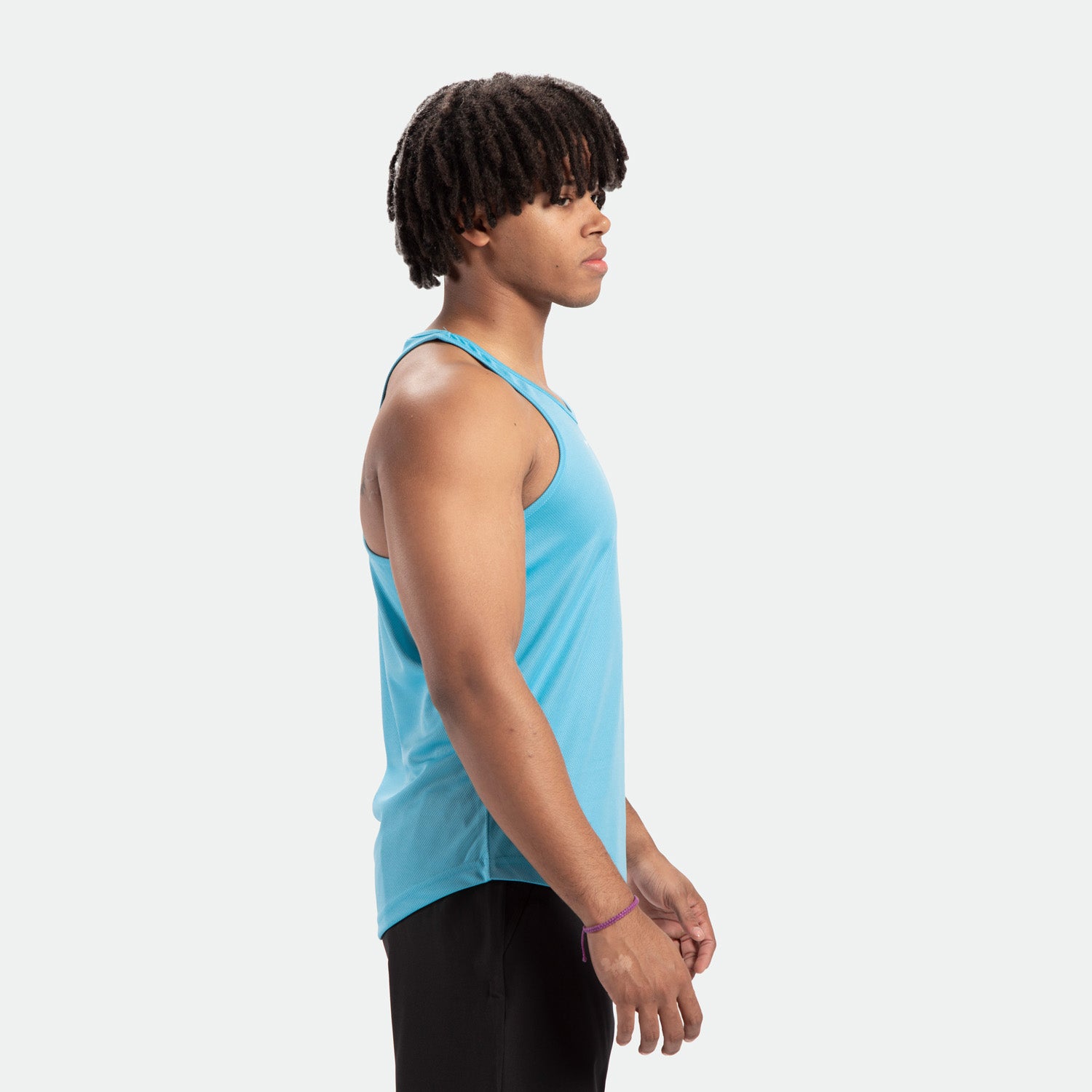 a fit man wearing  tank Blue- grotto with pants black 