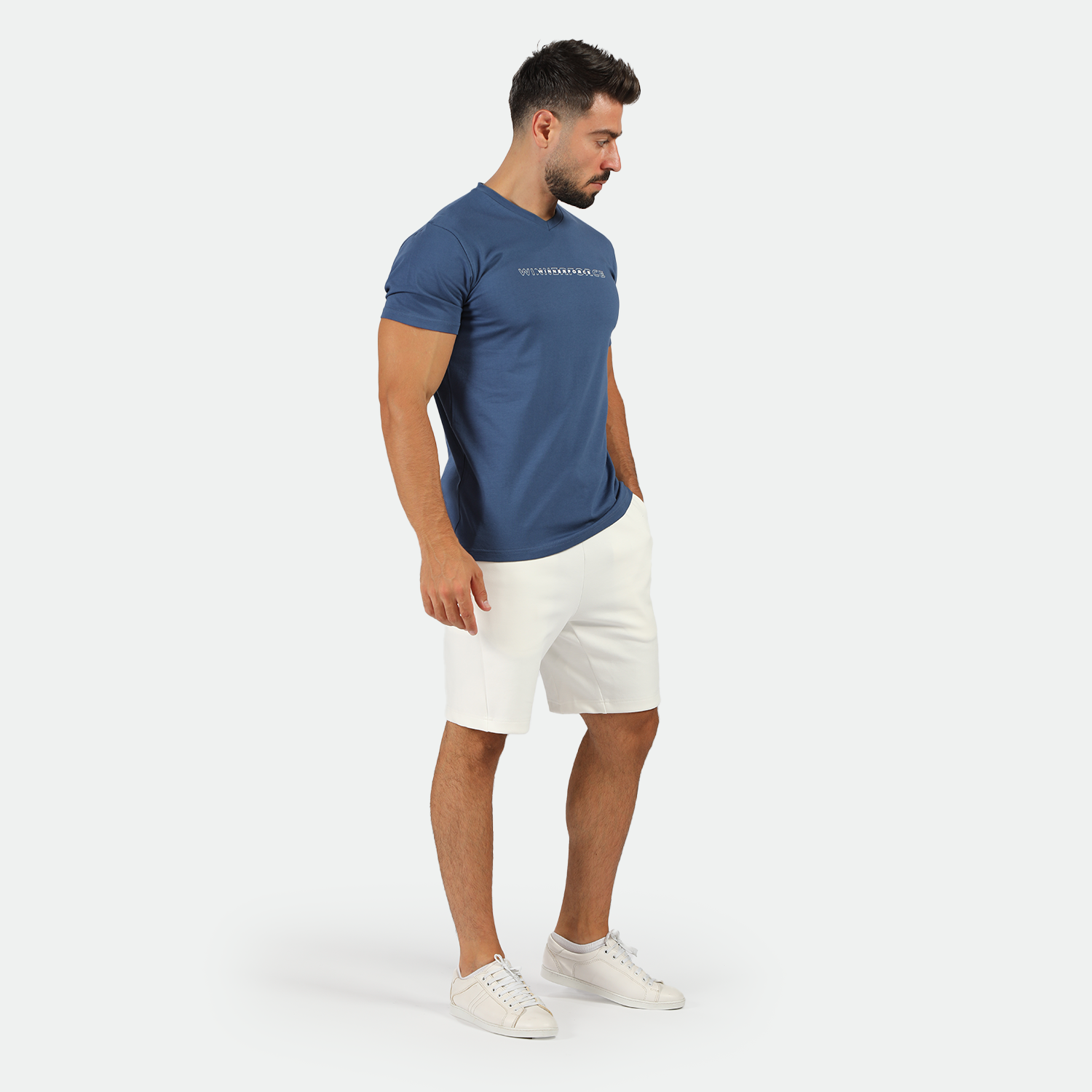 a fit man wearing t-shirt blue opal with short white ,plus shoes white 