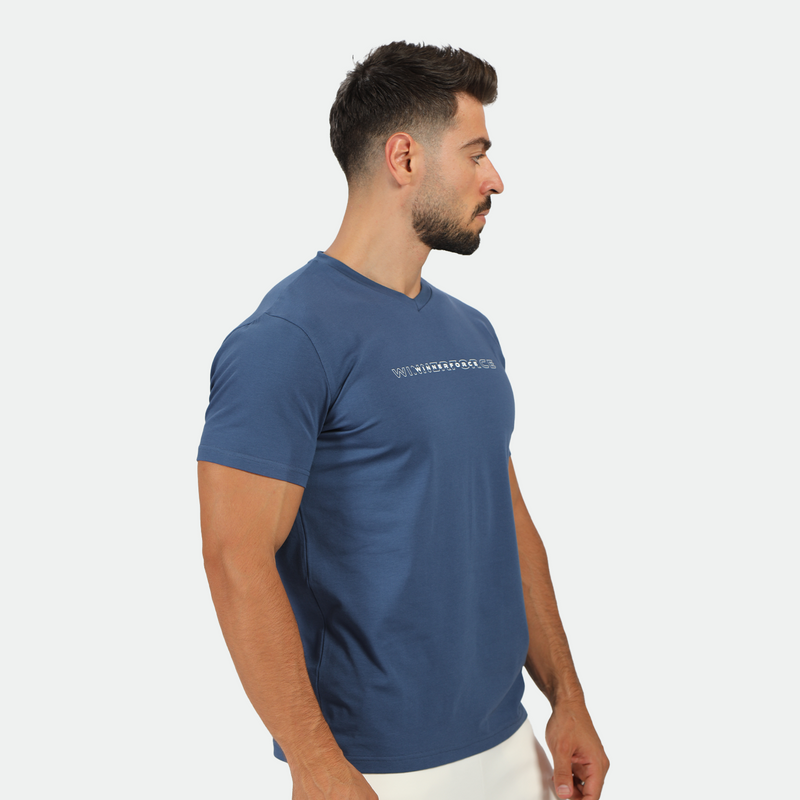 a fit man stand at right and wearing t-shirt blue opal with short white 