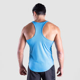 a back view for fit man wearing tank blue with pants grey 