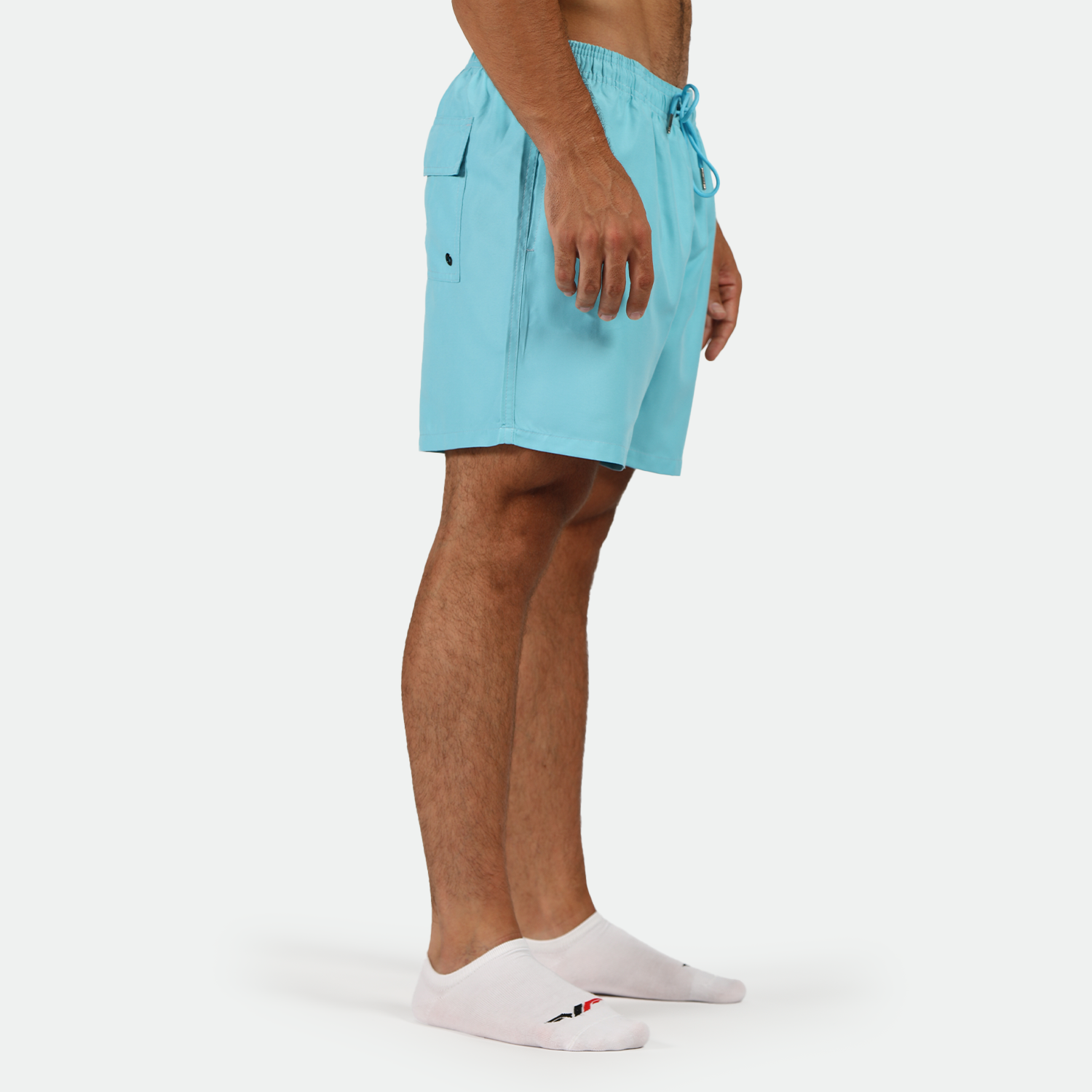 a fit man stand at right and wearing short BLUE-TOPAZ with socks white 
