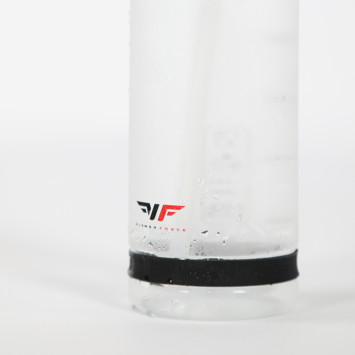 Close-up of a frosted glass bottle with a black band at the base. Water droplets cover the surface, and a red and black logo is visible. Clean, refreshing feel.