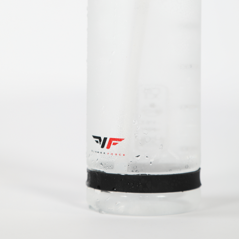 Close-up of a frosted glass bottle with a black band at the base. Water droplets cover the surface, and a red and black logo is visible. Clean, refreshing feel.