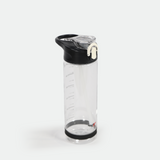 Clear water bottle with a black lid and a white latch, measuring marks on the side, resting upright on a white background. Simple and practical design.