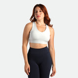 a fit woman wearing bra grey  and legging  black 