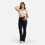 a fit woman stand with pose  and wearing bra grey with legging black 