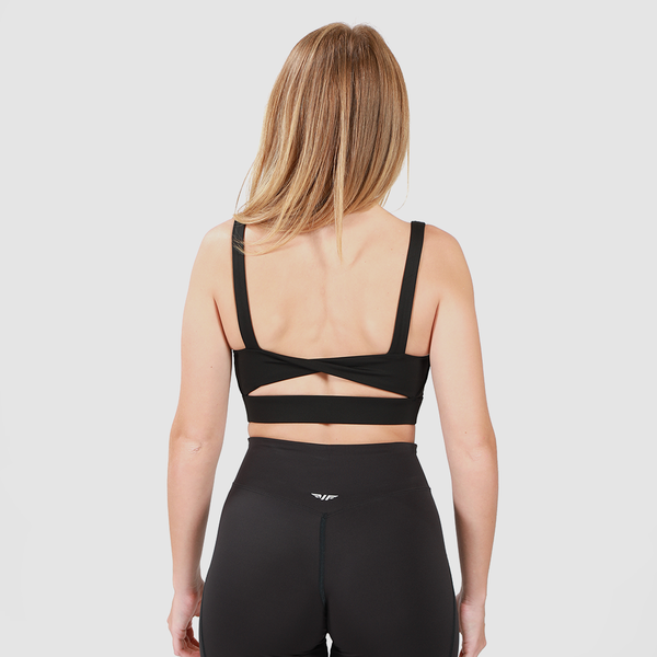 a back view for woman wearing a  matching bra and legging black , with logo ,plus background light grey 
