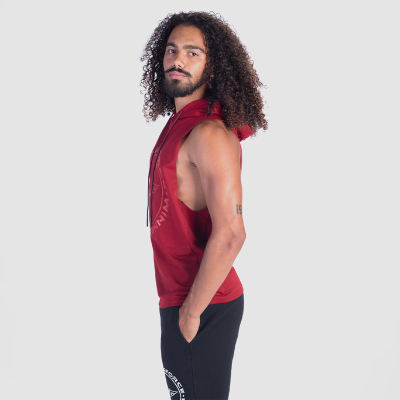 a fit man stand at right and wearing half hoodie burgundies red with pants black 