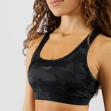 a model she wearing a bra backcamotop ,have logo in half with background light grey