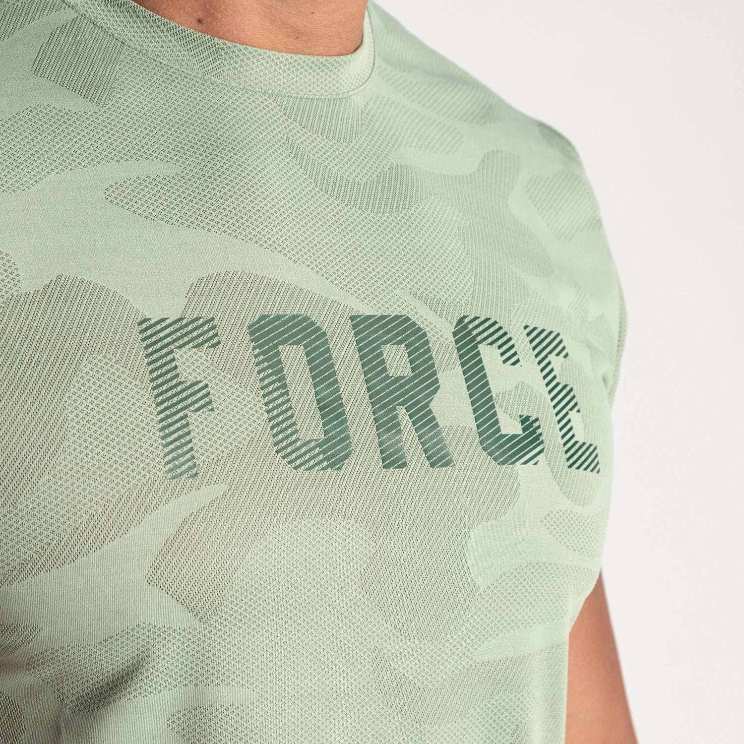 close up view for fit  man wearing camo t-shirt green by with logo 