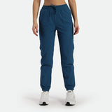 a fit woman wearing cargo pant blue with shoes white ,plus the background is light grey 