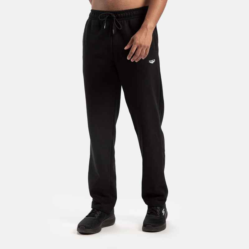 a fit man wearing  pants black with logo ,plus the shoes black 