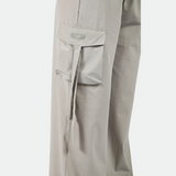 close up view for pocket of pant with logo plus the background is light grey 