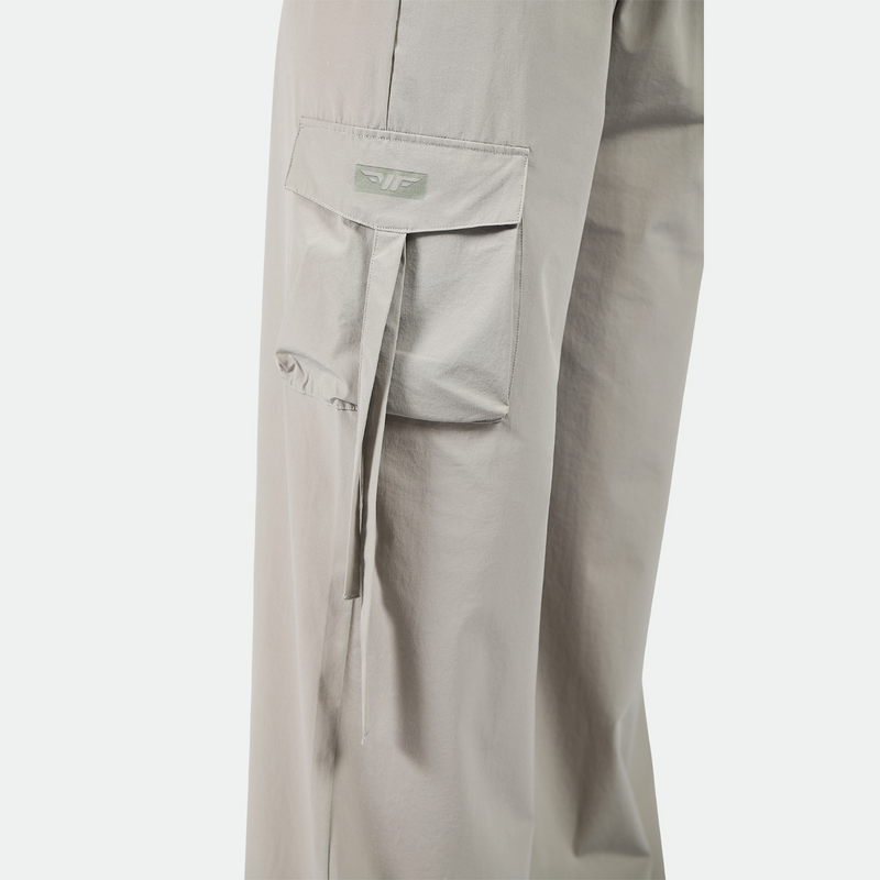 close up view for pocket of pant with logo plus the background is light grey 