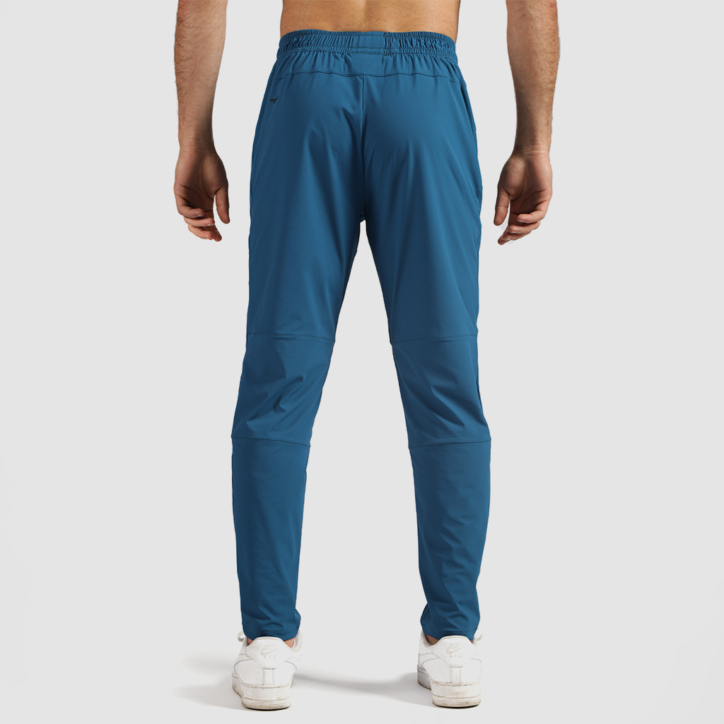 a back view for fit man wearing pants   classic blue  with shoes white 