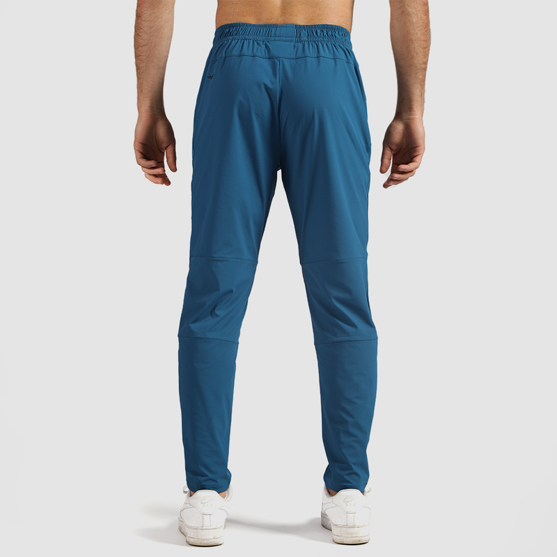 a back view for fit man wearing pants   classic blue  with shoes white 